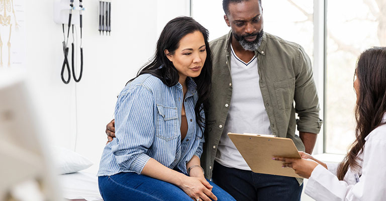 couple in exam room with doctor