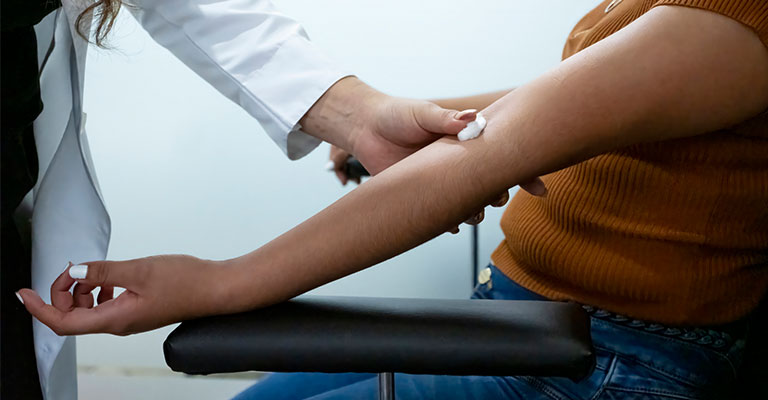 woman prepping for shot in the arm