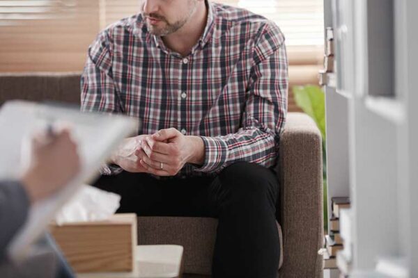 Man sitting on a couch for infertility diagnosis