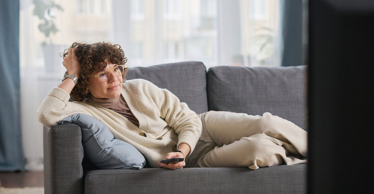 woman resting on sofa