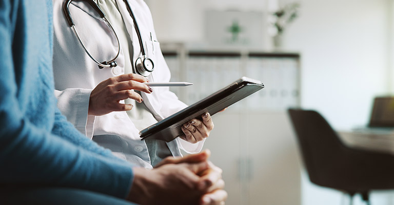 provider and patient discussing chart on ipad, closeup of hands
