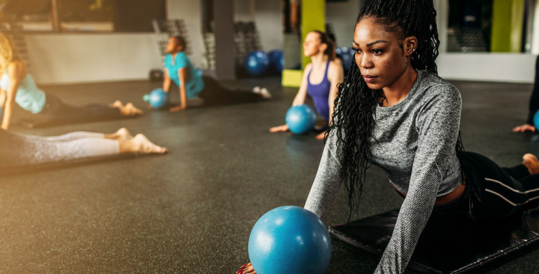 black woman exercising at gym