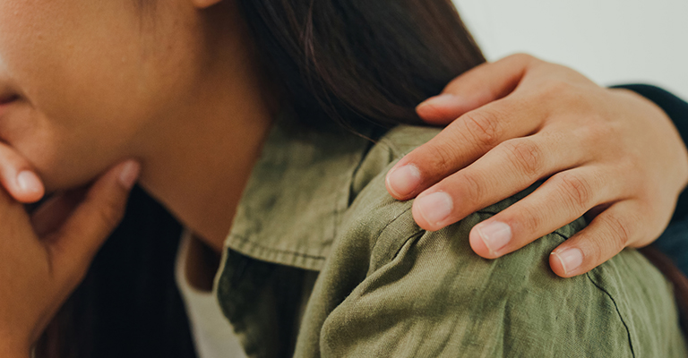 contemplative woman with an arm around her