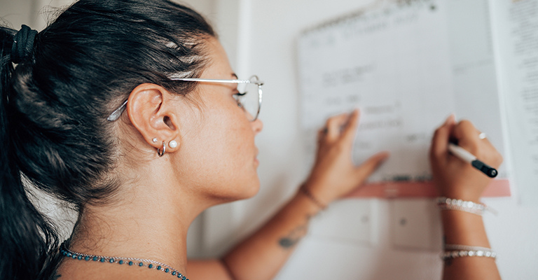 young woman writing on whiteboard