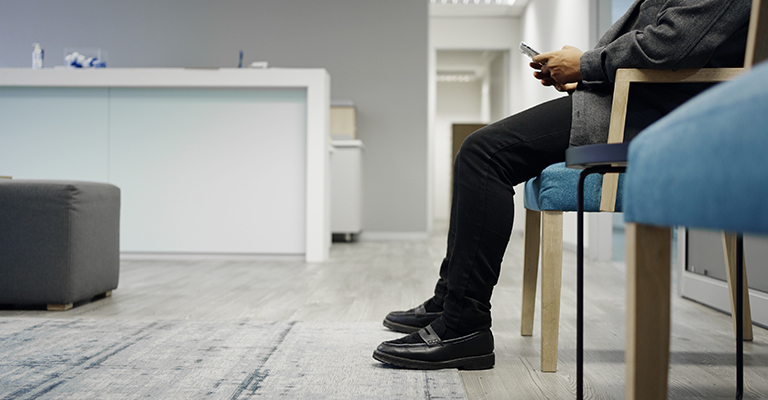 closeup of legs waiting in doctor waiting room