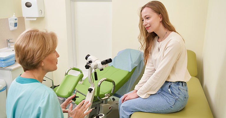 female patient sitting on exam table