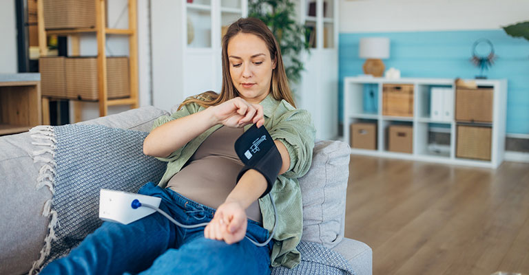 pregnant woman with blood pressure cuff