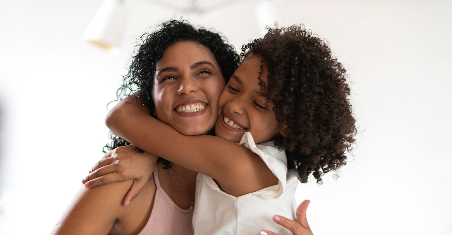 happy woman and daughter hugging