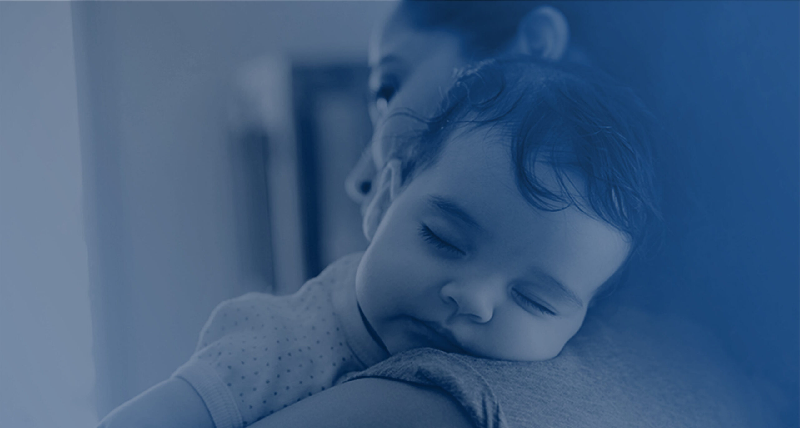 baby sleeping on mother's shoulder