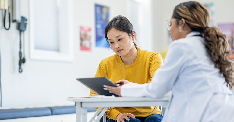 young woman reviewing chart with provider