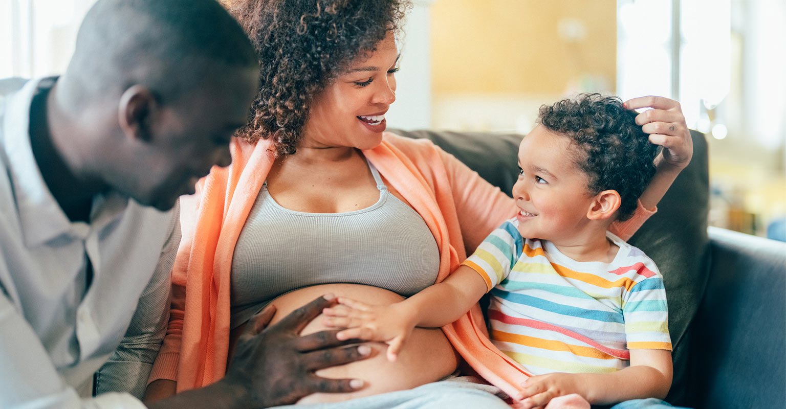 pregnant couple with their son