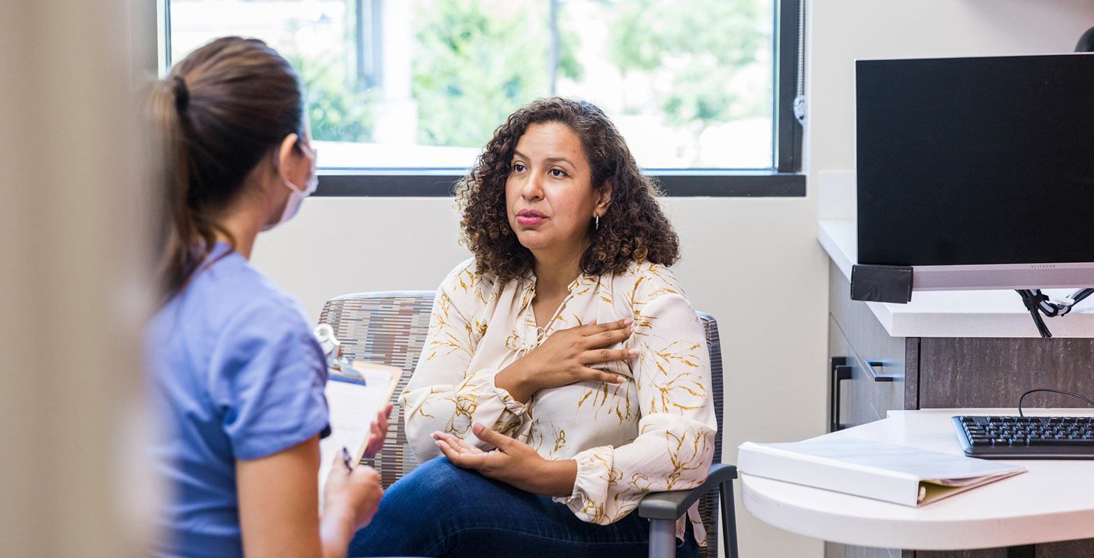 woman discussing menopause symptoms with provider