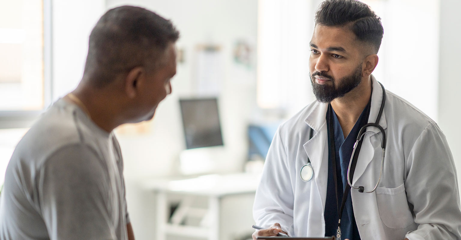 male healthcare provider having discussion with male patient