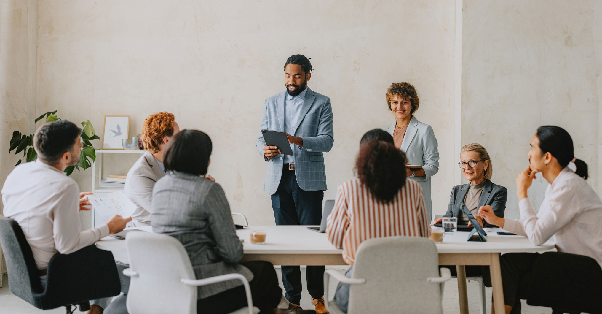 two colleagues presenting to the rest of the company