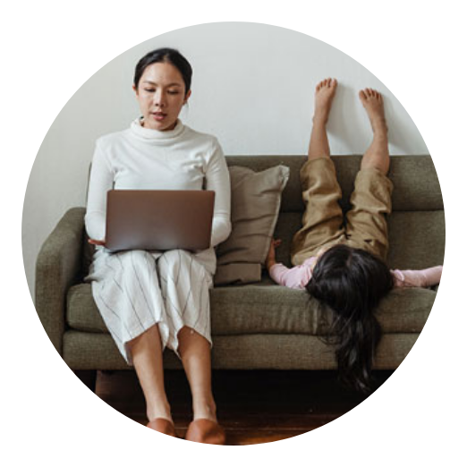 mother on laptop seated next to daughter