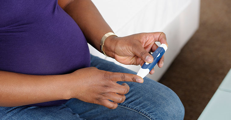 pregnant woman with glucose monitor