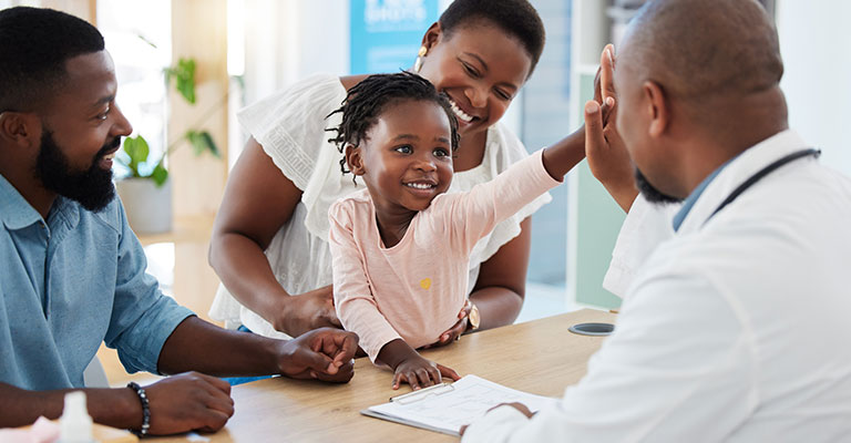 young child high fiving her medical provider