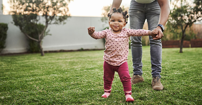toddler walking in backyard