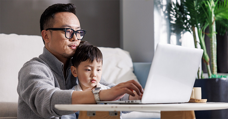 parent with child in front of laptop