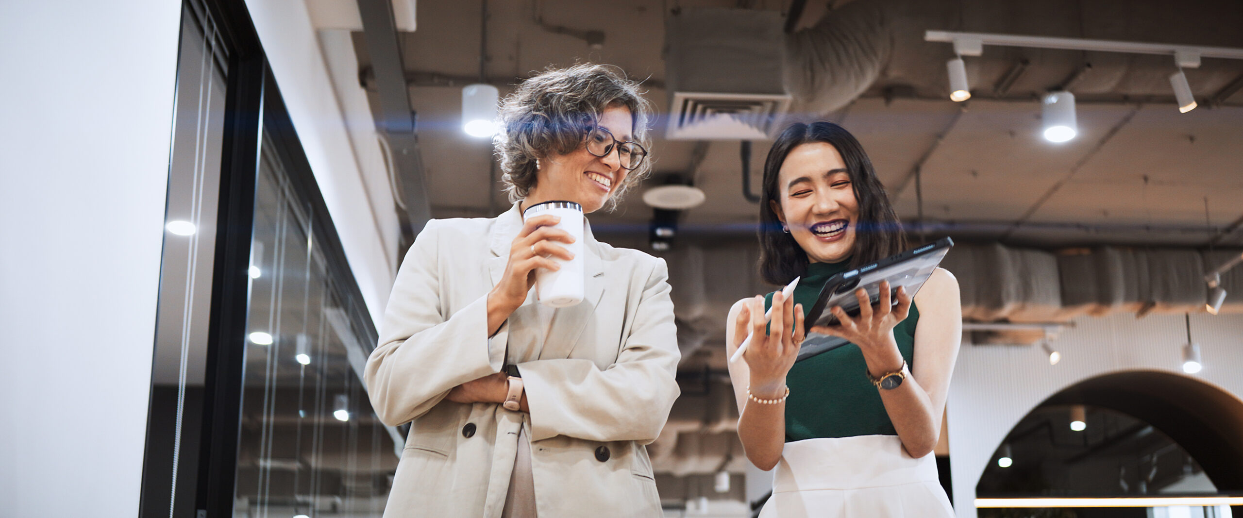 two happy women in the workplace