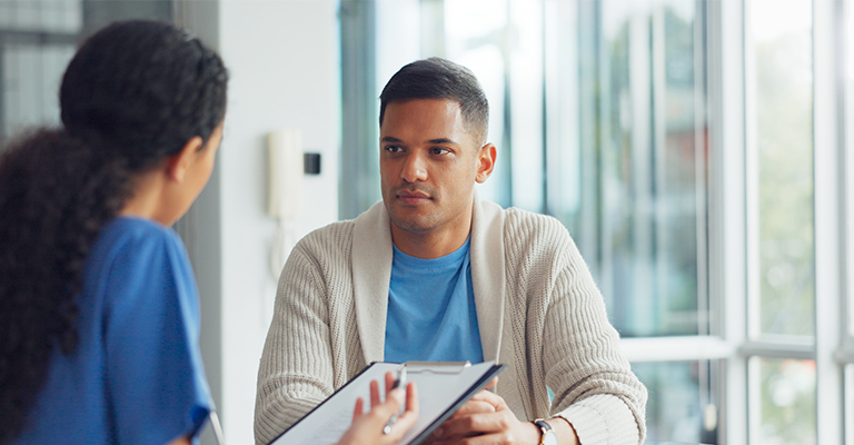nurse consulting with male patient