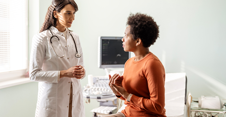 patient explaining situation to female doctor