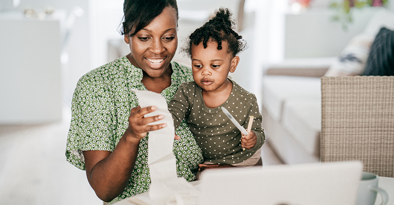 a toddler and mom looking at long receipt