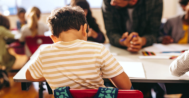 rearview image of child doing lessons at school
