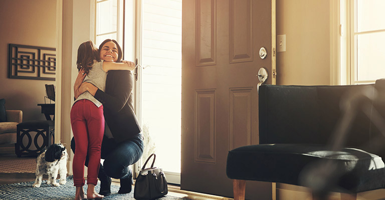child hugging mother at the door