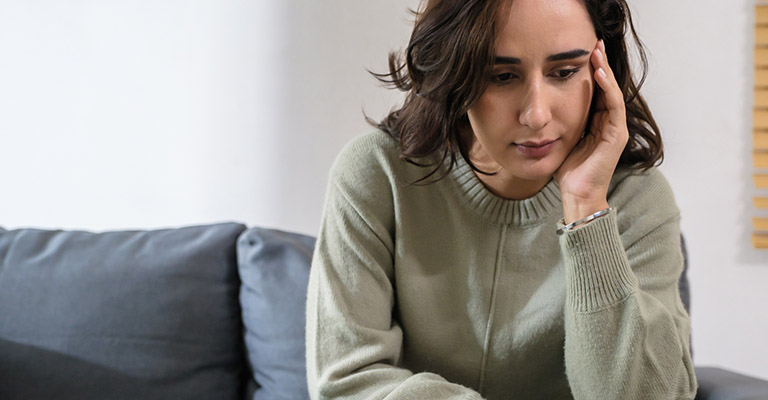 concerned and exhausted seated woman
