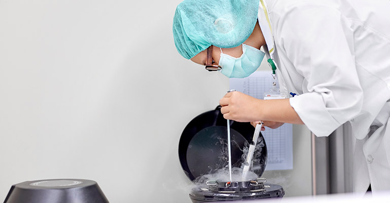 scientist handling specimens in lab setting