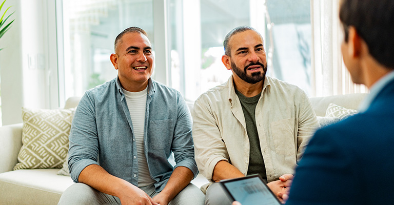 happy gay couple meeting about surrogacy