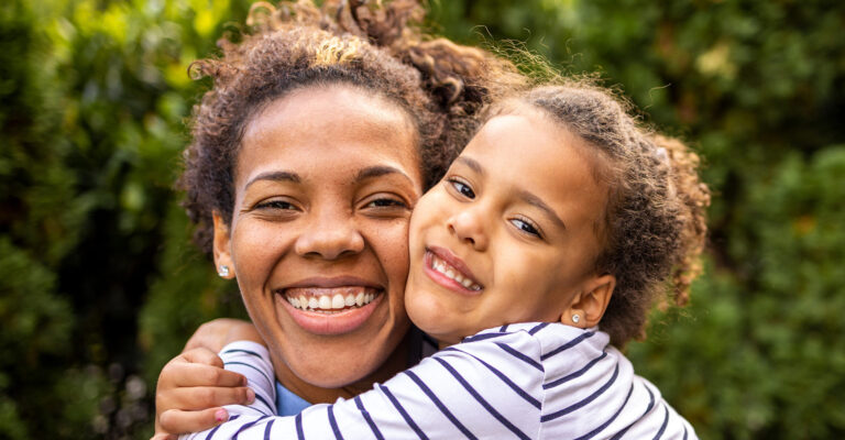 child hugging smiling mother