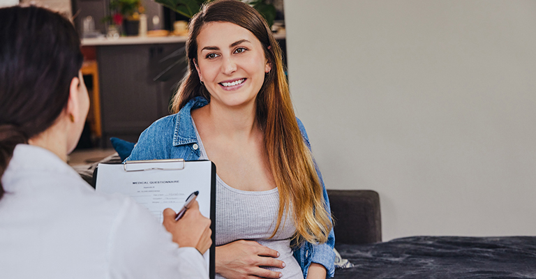 happy pregnant woman responding to questions