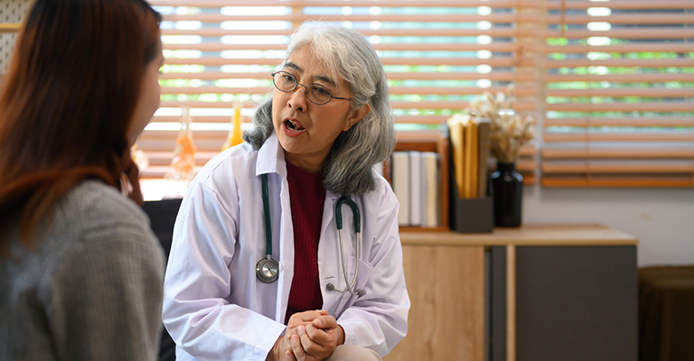older female doctor counseling a patient