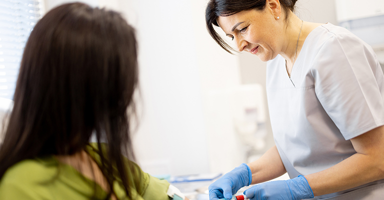 nurse drawing blood from a patient