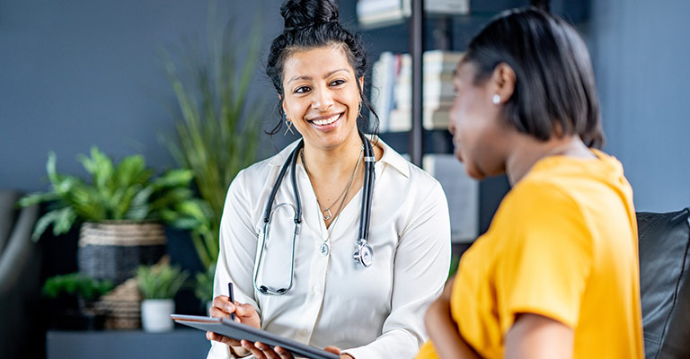 smiling doctor listening to patient