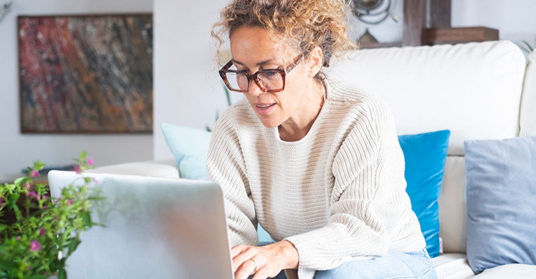 menopausal woman browsing on laptop