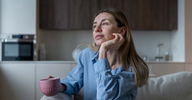 thinking woman seated on couch